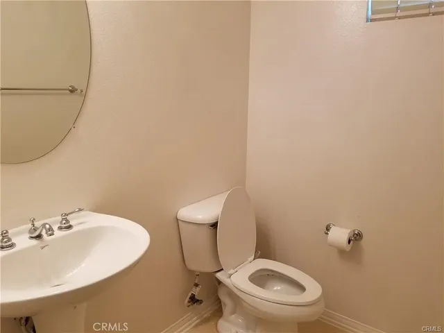 a white toilet sitting next to a bathroom sink
