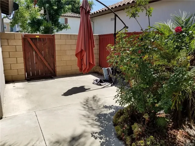 a view of a house with a wooden fence