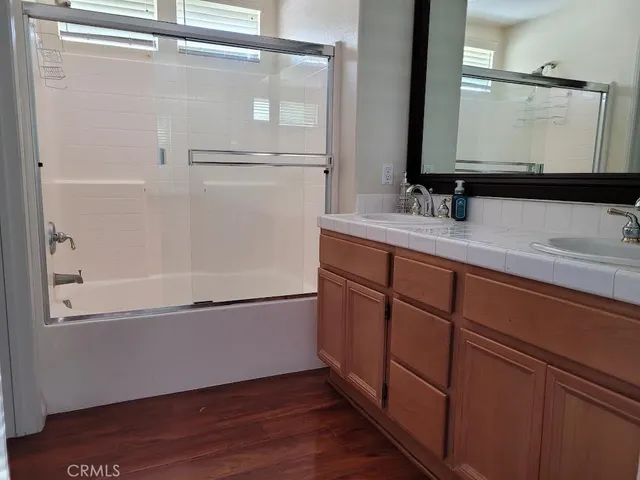 a bathroom with a tub sink and mirror