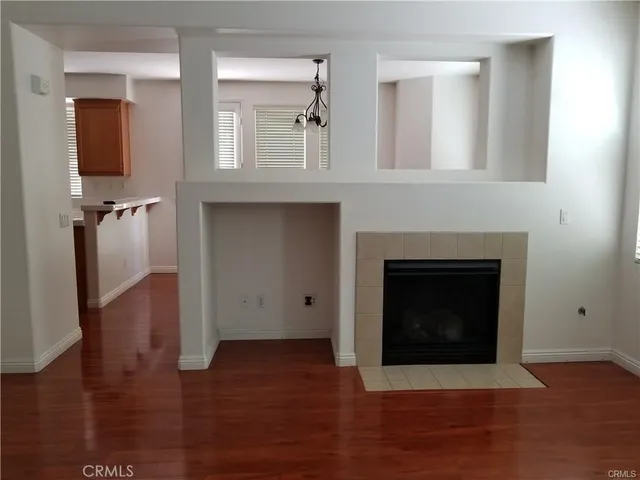 a living room with wooden floors and a fireplace