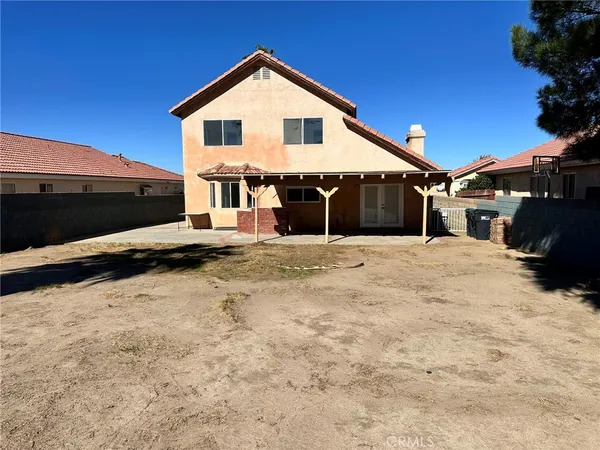 a view of a house with a wooden fence