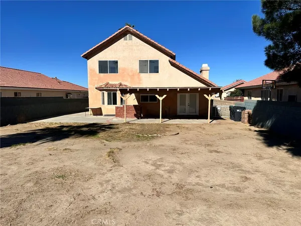 a view of a house with a wooden fence
