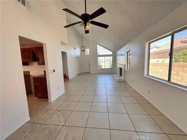 a view of a livingroom with a ceiling fan and window