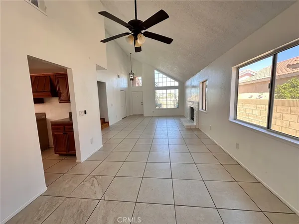 a view of a livingroom with a ceiling fan and window