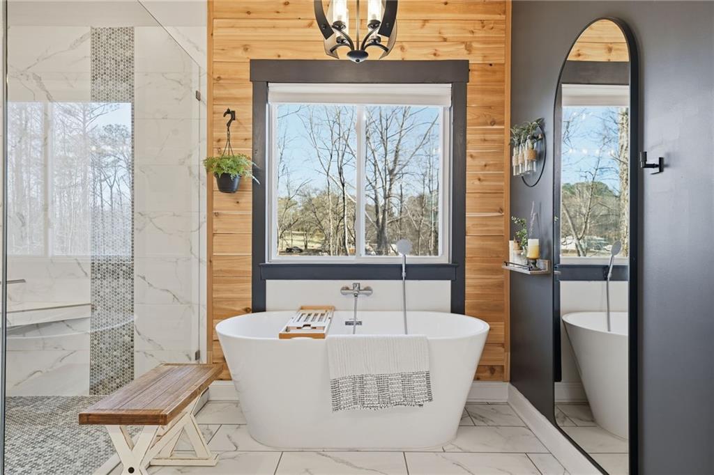 a white bath tub sitting in front of a bathroom