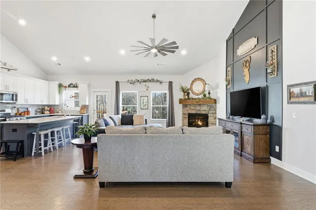 a kitchen with stainless steel appliances granite countertop a refrigerator a stove a sink and a refrigerator