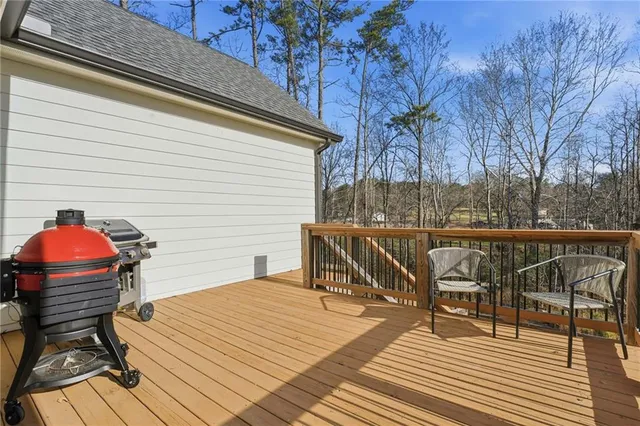 a bedroom with a bed chair and a large window
