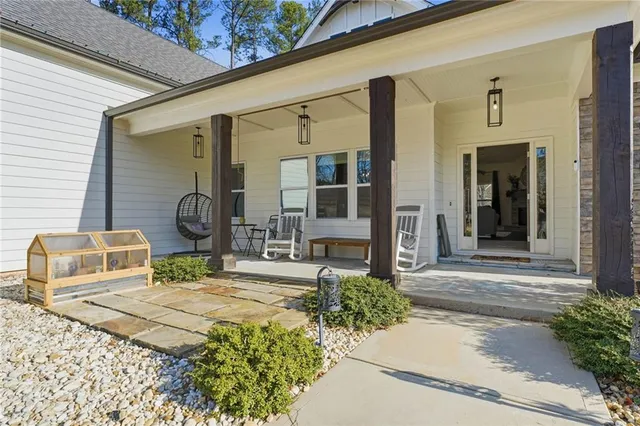 a living room with furniture kitchen view and a wooden floor