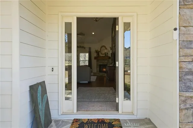 a view of a dining room with furniture a chandelier and wooden floor