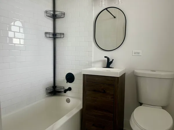 a bathroom with a sink a toilet and a mirror