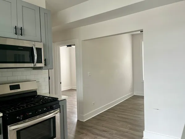a kitchen with a refrigerator stove and microwave