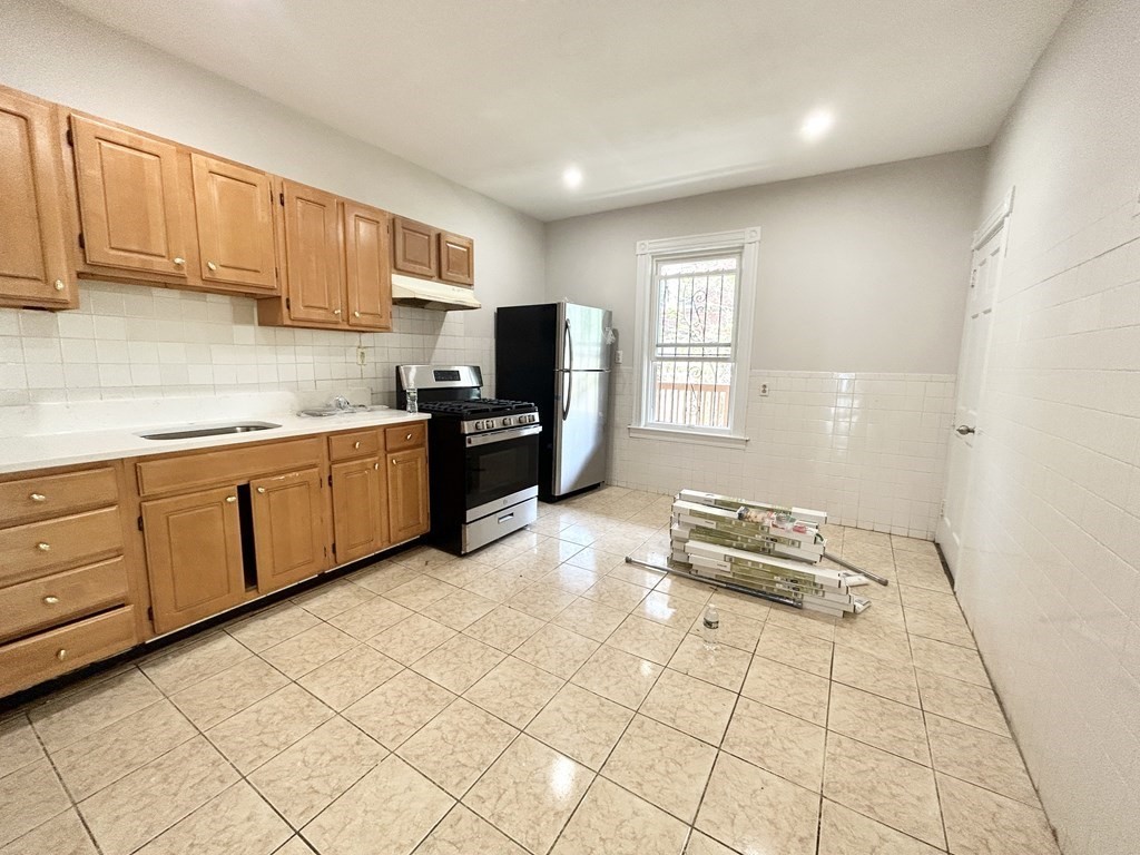 a kitchen with stainless steel appliances a stove sink and cabinets
