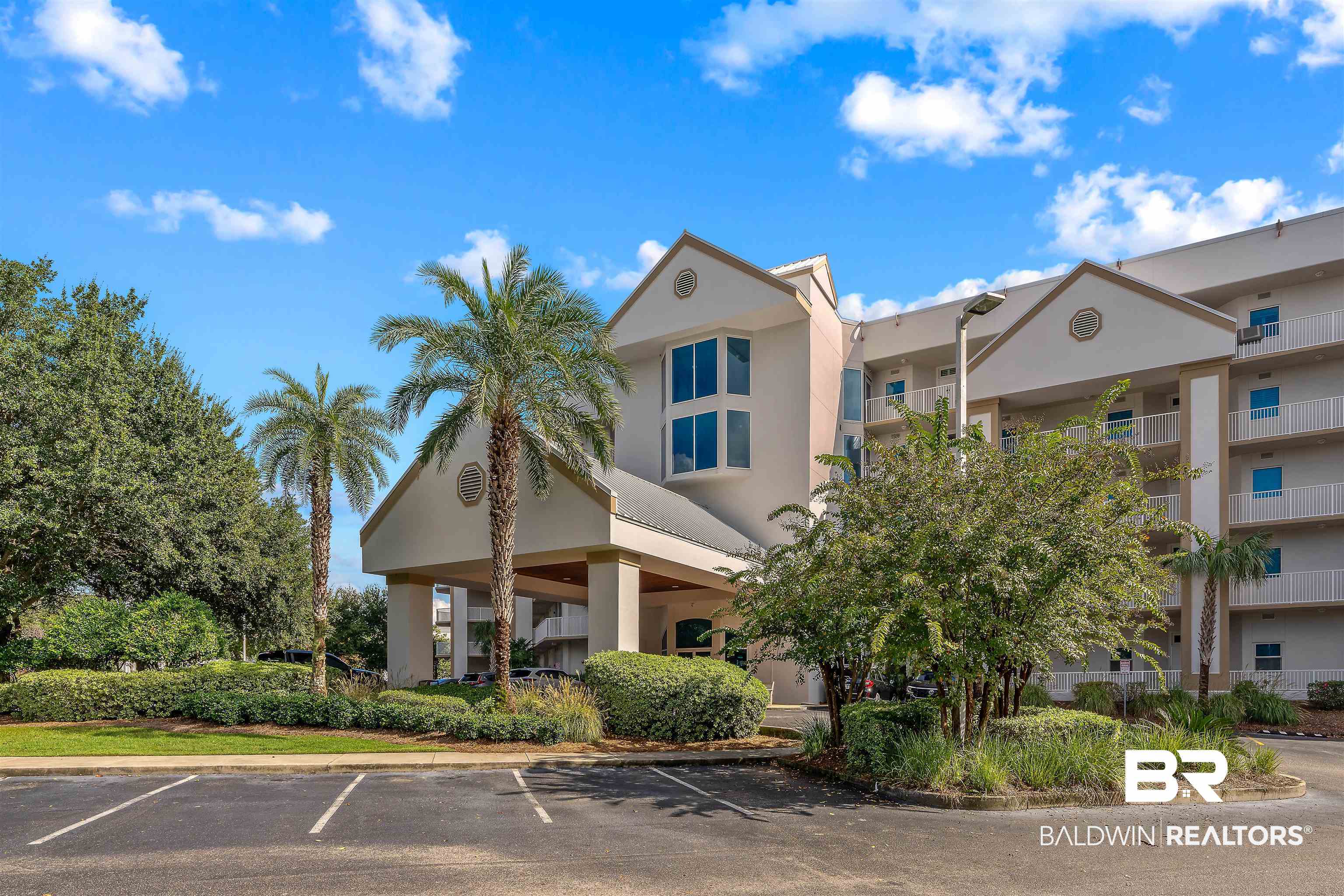 27800 Canal Road, Unit 113 Orange Beach, AL 36561 - Photo 1 of 35 View of building exterior featuring uncovered parking