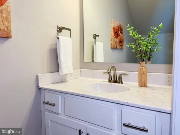 a bathroom with a sink a vanity and a mirror