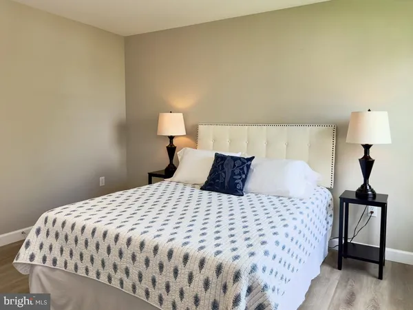 a bedroom with a bed and a lamp