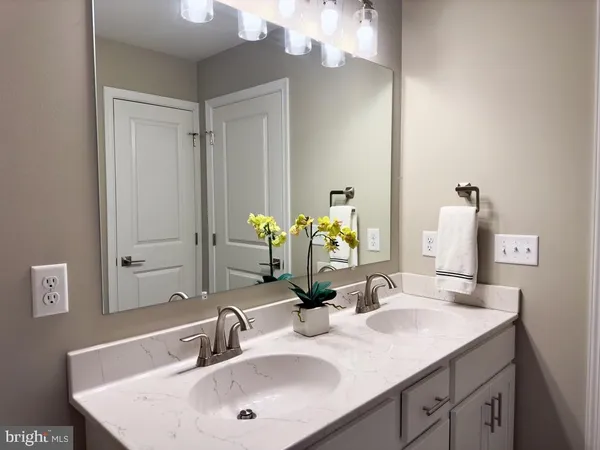 a bathroom with a sink vanity and a mirror
