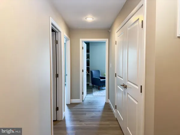 a view of a hallway with a wooden floor