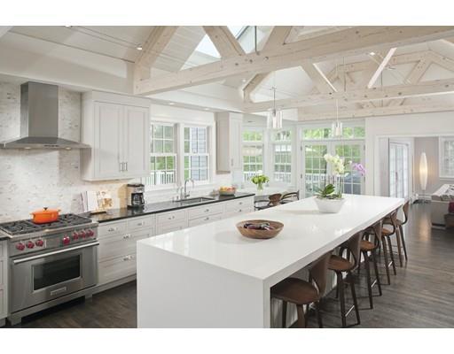 3 Alexandra Way Hingham, MA 02043 - Photo 3 of 30 a kitchen with a stove a sink a kitchen island with a dining table and chairs