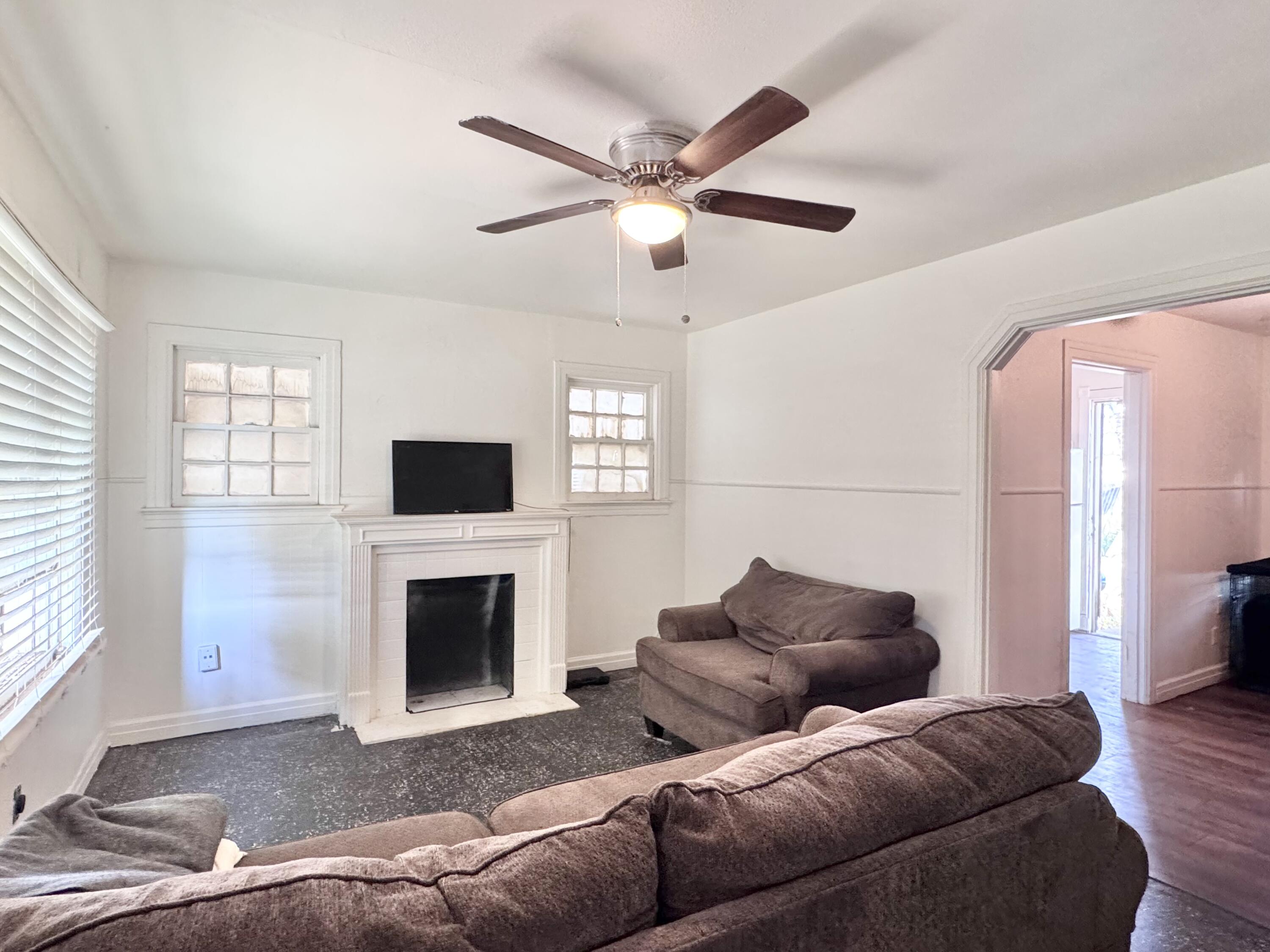 2912 Amherst Street Lubbock, TX 79415 - Photo 2 of 10 a living room with furniture and a fireplace