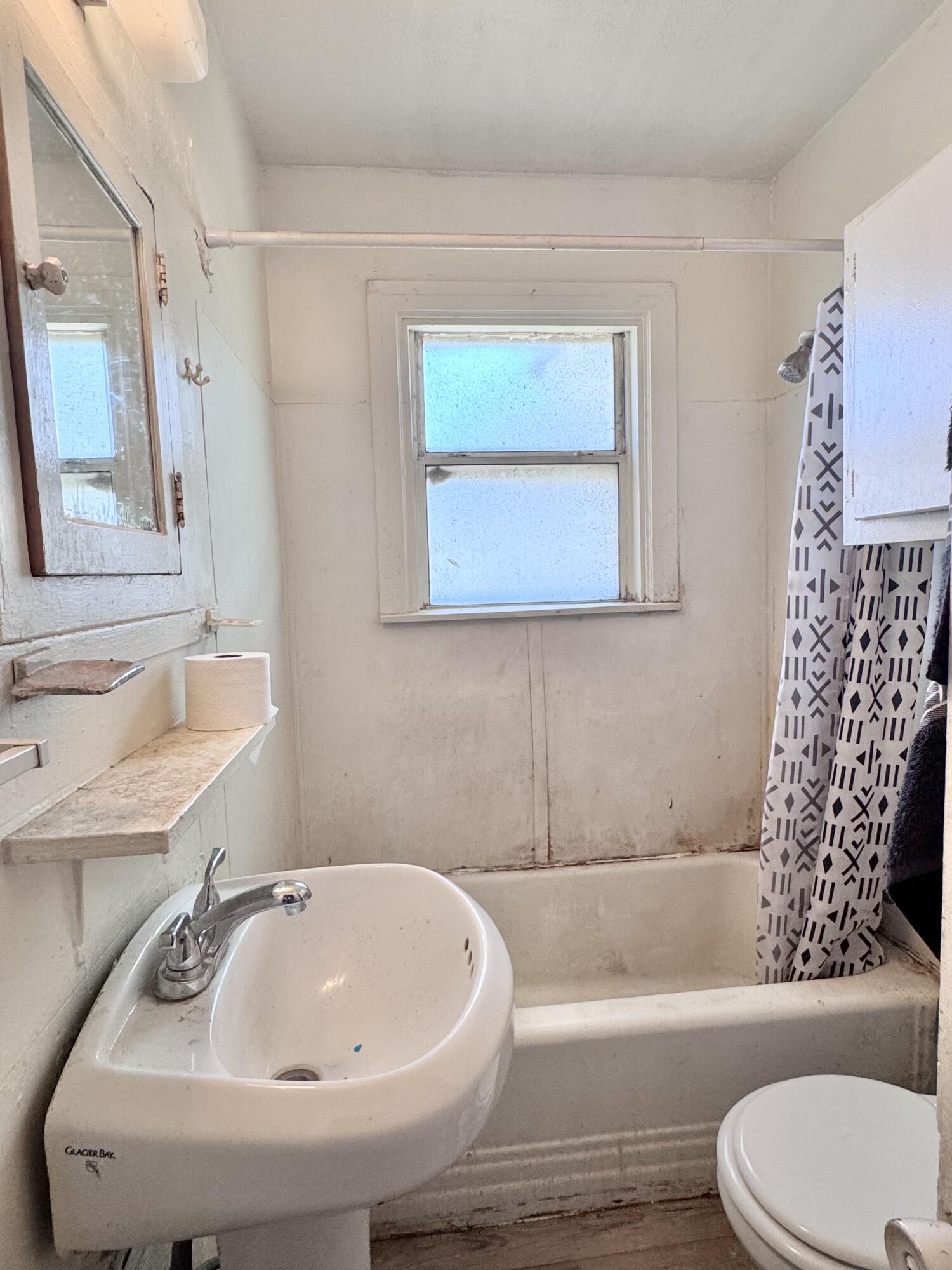 2912 Amherst Street Lubbock, TX 79415 - Photo 8 of 10 a bathroom with a sink a toilet and a bathtub