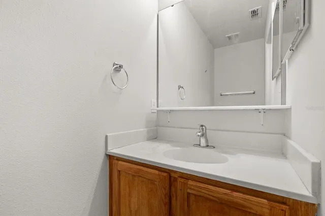 a bathroom with a sink and vanity