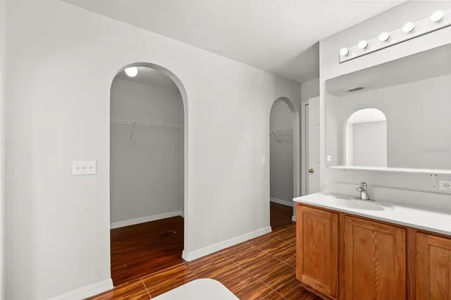 a spacious bathroom with a double vanity sink and a mirror