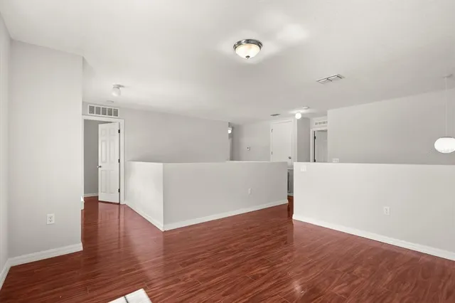 a view of a kitchen with wooden floor