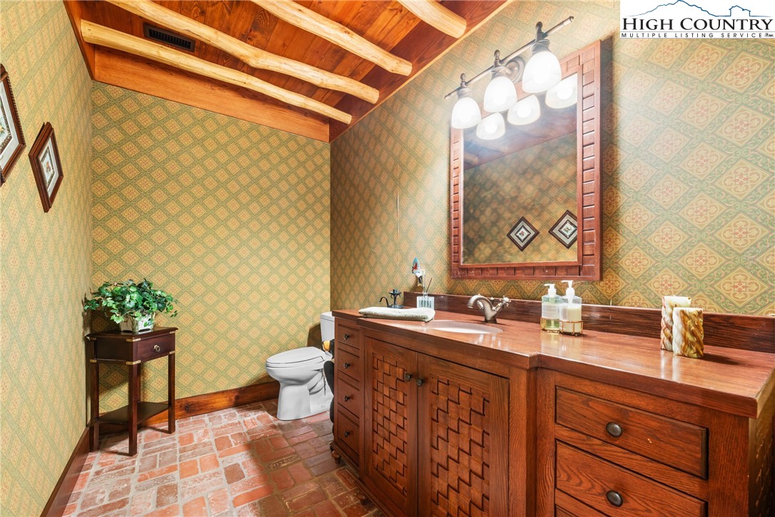 333 Windy Ridge Road Vilas, NC 28692 - Photo 33 of 46 a bathroom with a sink a toilet and mirror
