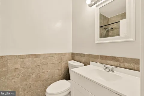a bathroom with a sink mirror and toilet