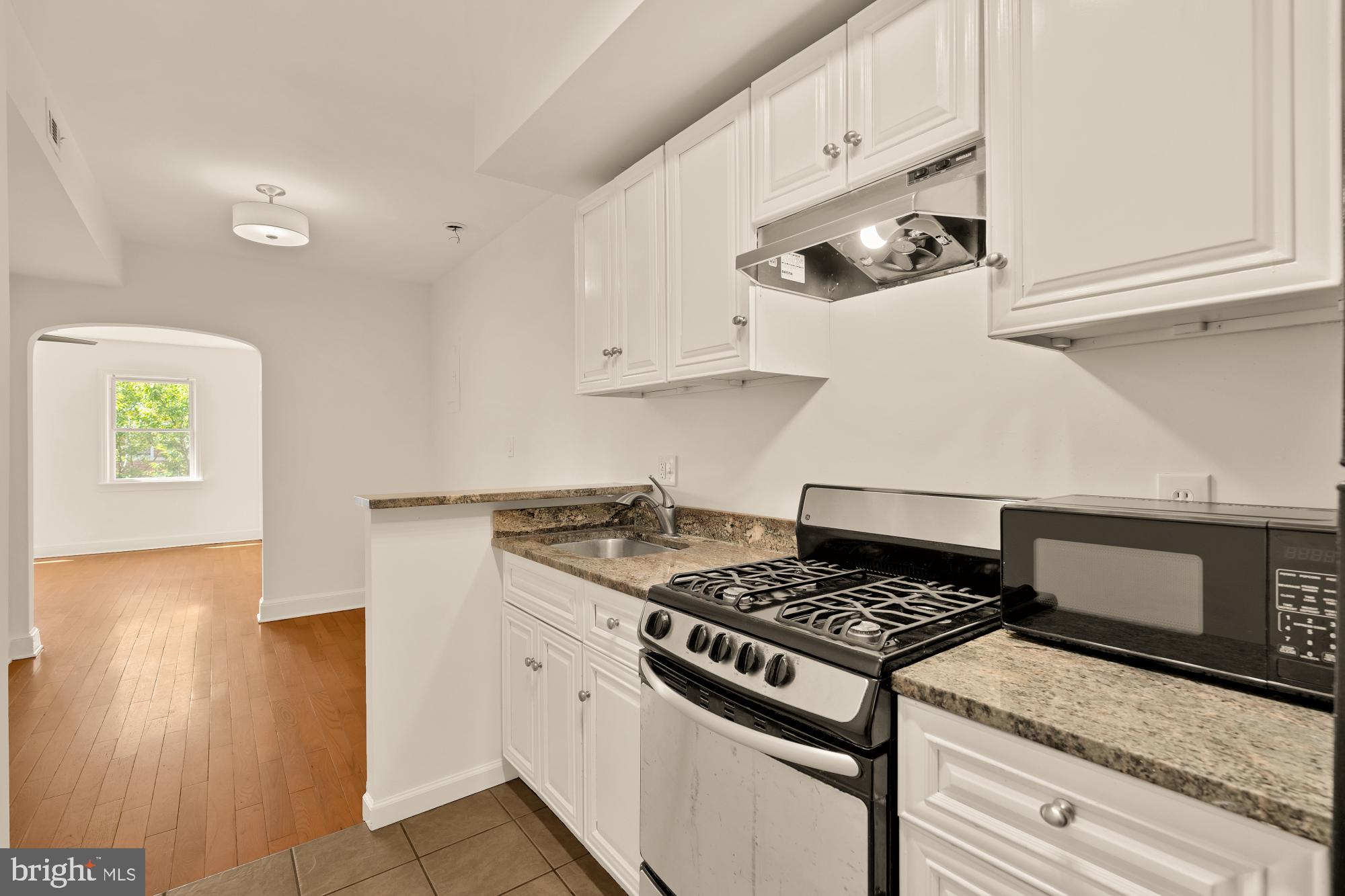 1254 Simms Place Northeast Washington, DC 20002 - Photo 15 of 21 a stove top oven sitting inside of a kitchen