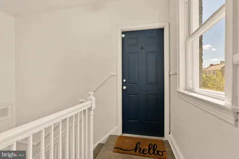 a view of a bedroom with a wooden door