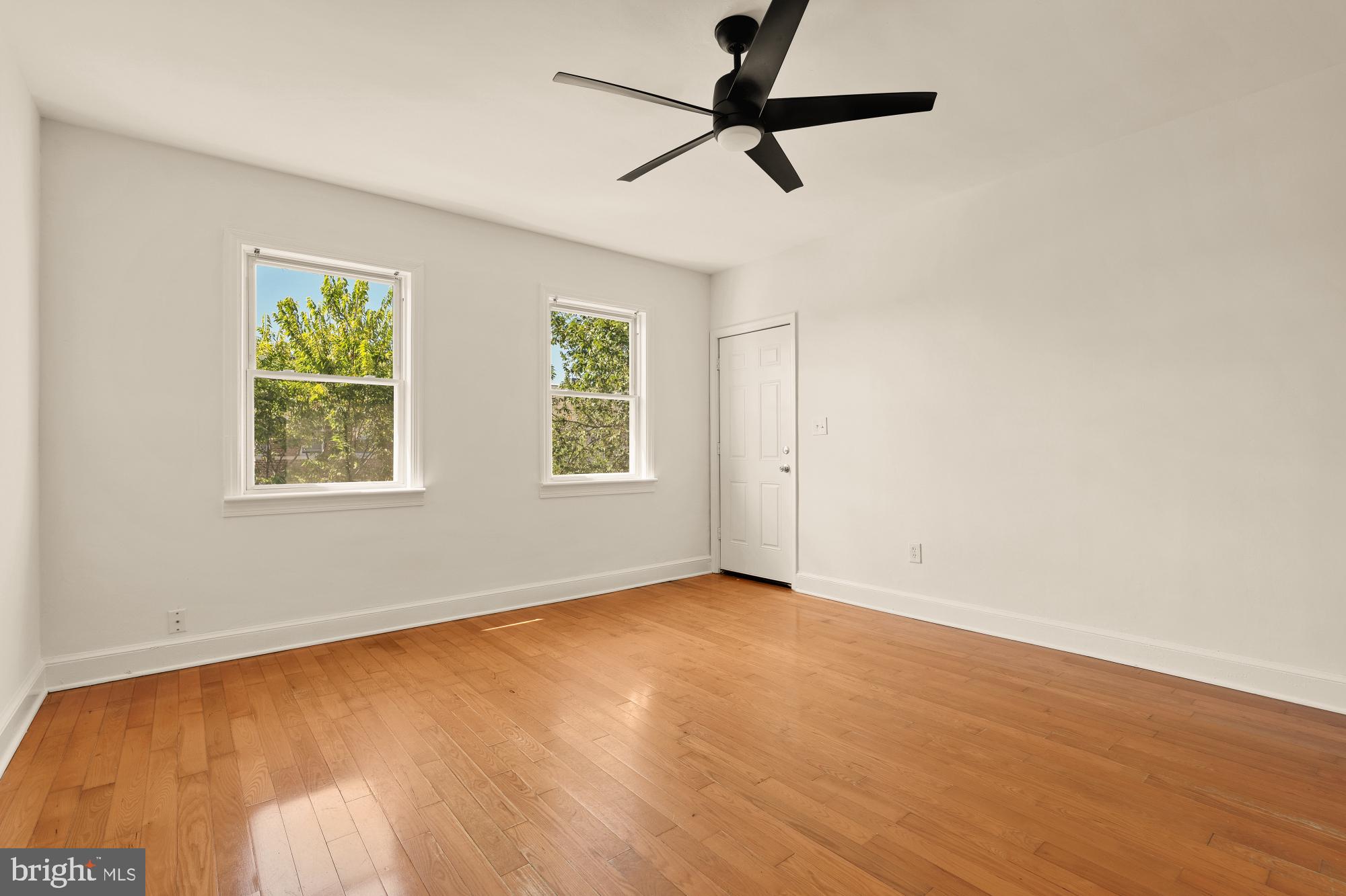 1254 Simms Place Northeast Washington, DC 20002 - Photo 7 of 21 an empty room with windows and fan