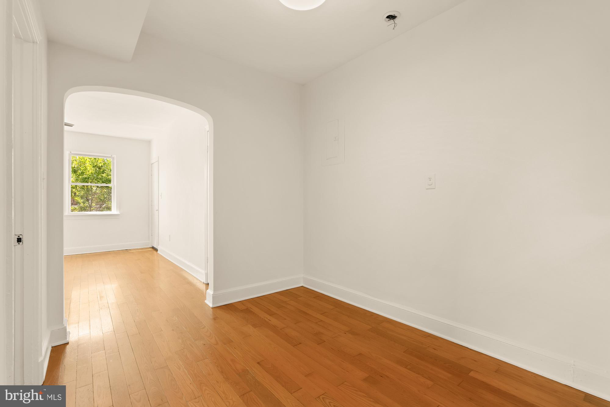 1254 Simms Place Northeast Washington, DC 20002 - Photo 10 of 21 a view of an empty room with wooden floor and a window
