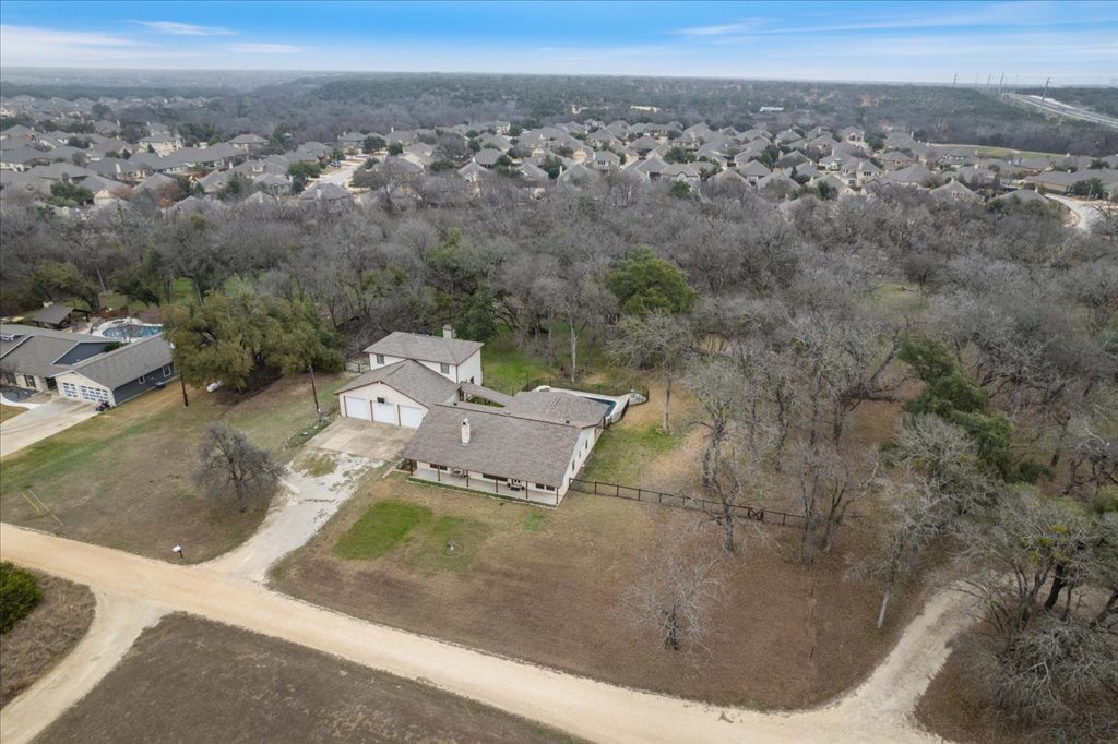 5014 Little Valley Road Leander, TX 78641 - Photo 5 of 20 An aerial perspective reveals a secluded residence surrounded by a mature tree canopy, offering tranquil living.