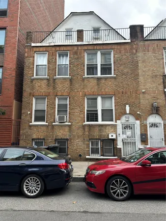 a front view of a house with parking space