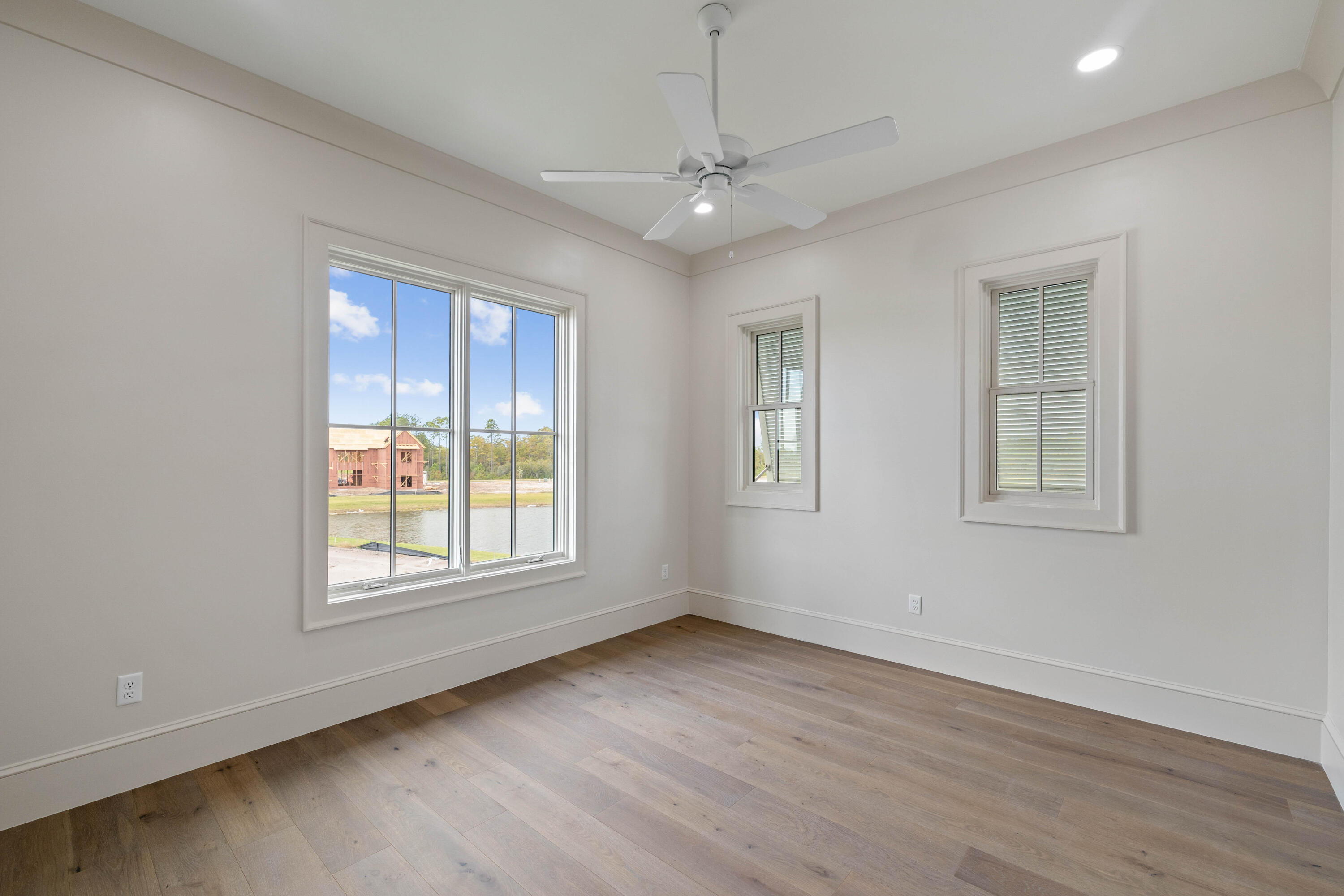 99 Morning Light Way Inlet Beach Inlet Beach, FL 32461 - Photo 79 of 97 an empty room with wooden floor chandelier and windows
