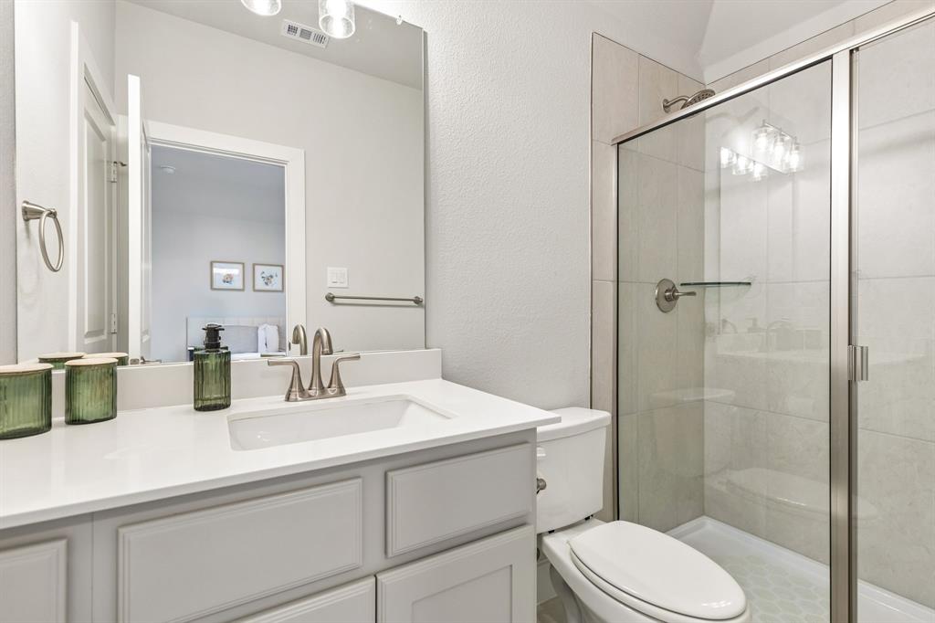 3004 Windy Rdg Road McKinney, TX 75071 - Photo 25 of 40 a bathroom with a sink toilet and shower