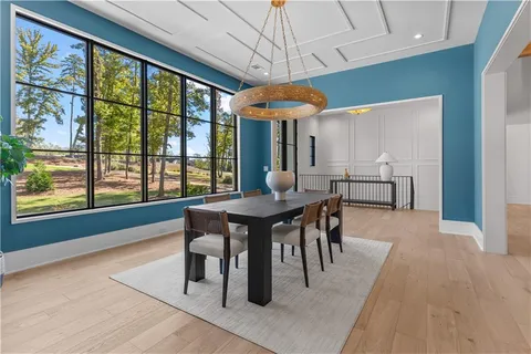 a living room with furniture a fireplace and a large window