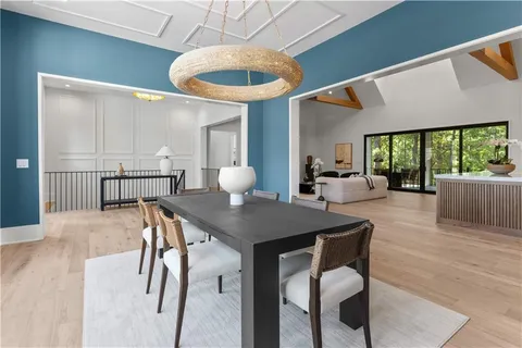 a large white kitchen with a large window