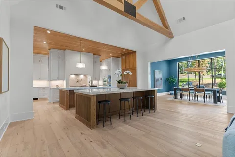 a living room with furniture a fireplace and a large window