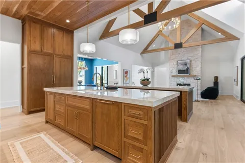 a view of hallway with a large window and couch