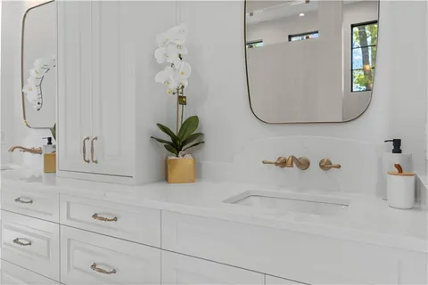 a bathroom with a toilet a sink a shower and mirror