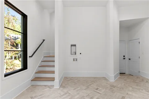 a view of an empty room with a fireplace and a window