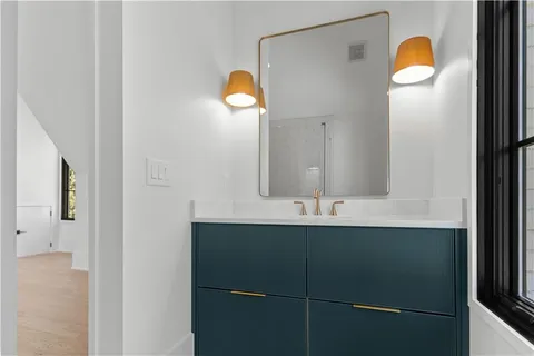 a view of a house with a small yard and large tree