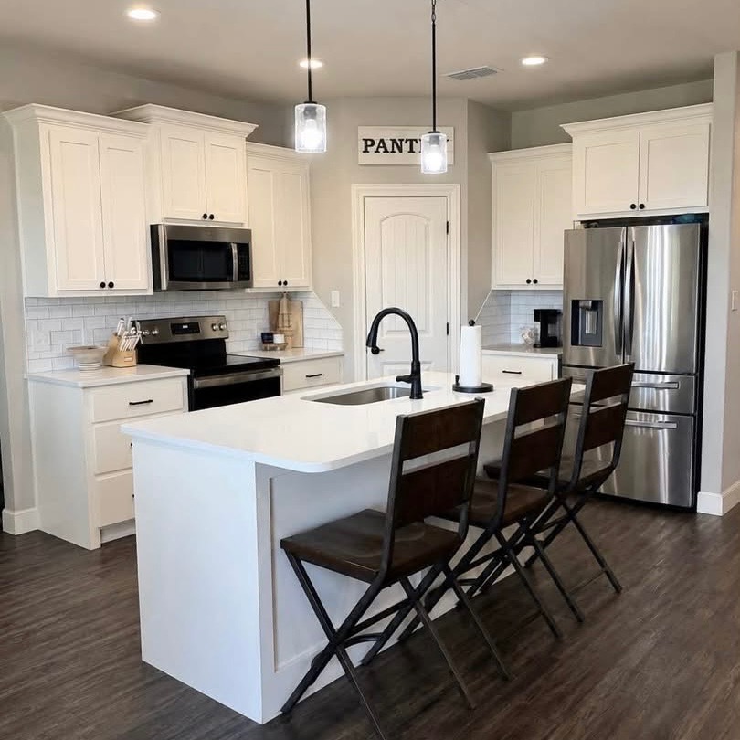 1114 Elkins Road Tuscola, TX 79562 - Photo 5 of 8 Gleaming stone countertops and a spacious central island anchor this modern culinary workspace.