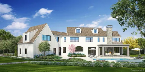 a front view of a house with garden and trees