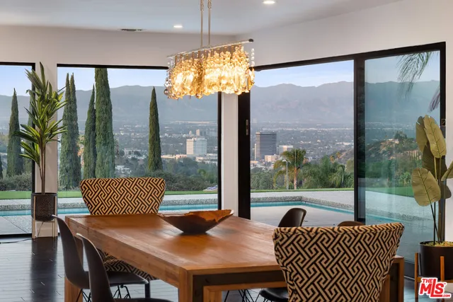 a view of a city from a balcony with furniture