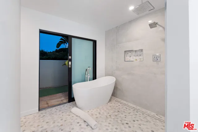 a view of a hallway with front door and wooden floor