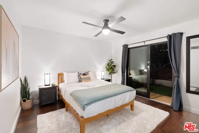 a bedroom with a bed and a mirror