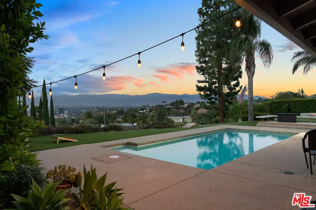 a view of a swimming pool with a back yard